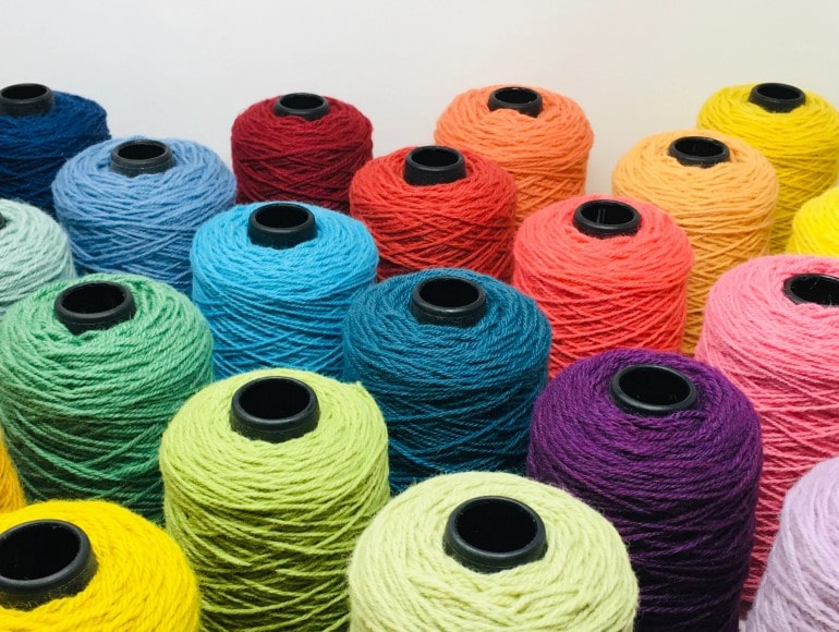 Colourful yarn spools used for carpet edging and binding